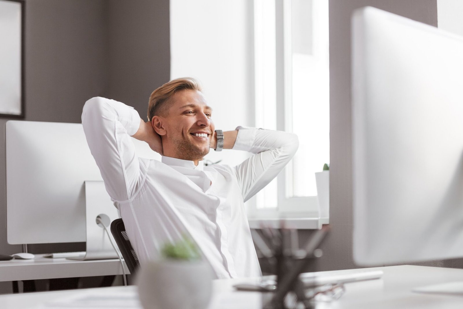 Smiling man looking at computer monitor